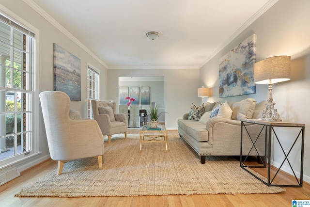 living room with crown molding and hardwood / wood-style flooring