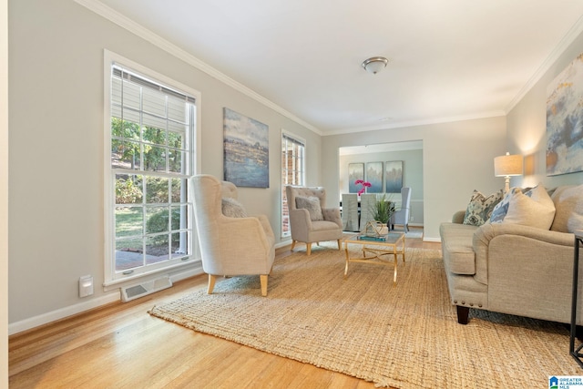 living area with ornamental molding and hardwood / wood-style floors