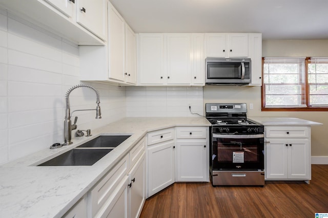 kitchen with white cabinetry, appliances with stainless steel finishes, sink, and dark hardwood / wood-style floors