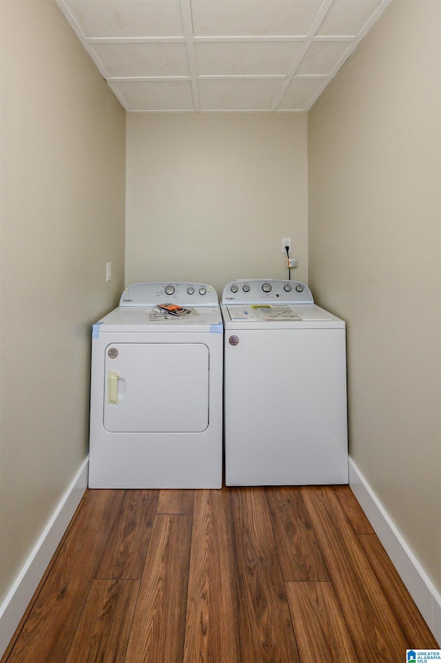 clothes washing area featuring independent washer and dryer and dark hardwood / wood-style floors