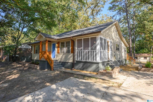 view of front of house with a patio area and a sunroom