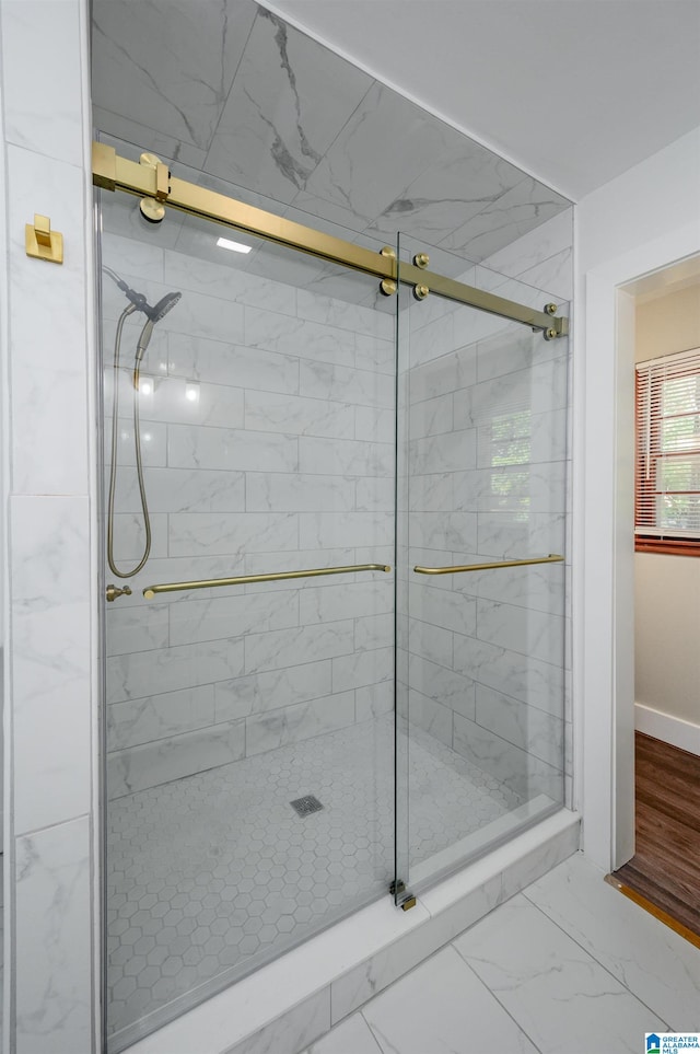 bathroom featuring a shower with door