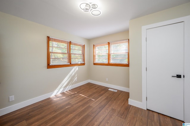 unfurnished bedroom featuring dark hardwood / wood-style flooring