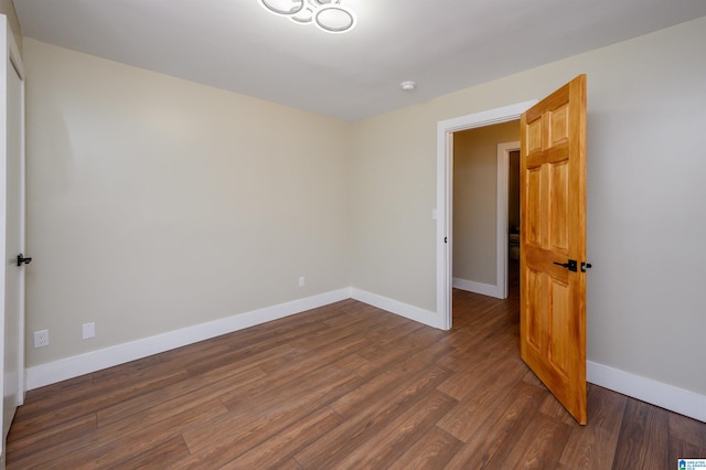 empty room with dark wood-type flooring