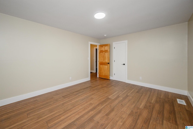 empty room featuring wood-type flooring