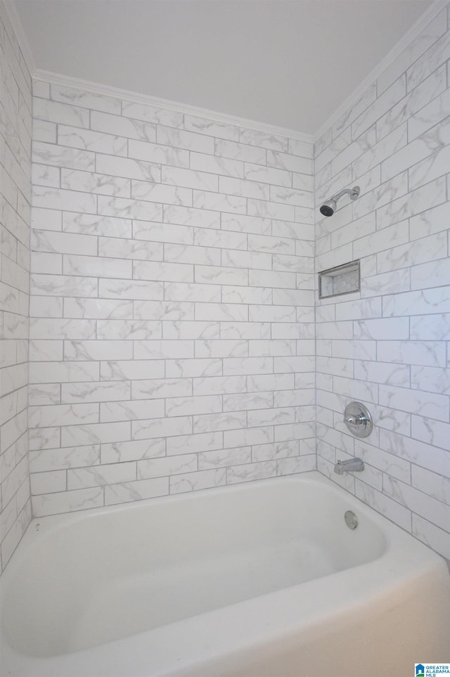 bathroom featuring ornamental molding and tiled shower / bath combo