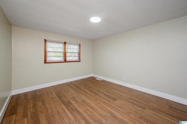 unfurnished room with hardwood / wood-style floors