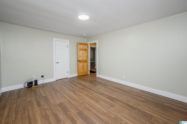 unfurnished room with wood-type flooring