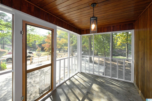 unfurnished sunroom featuring wooden ceiling