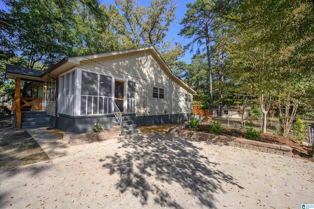 view of home's exterior with a sunroom