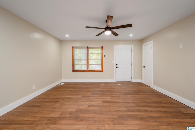 spare room with hardwood / wood-style floors and ceiling fan