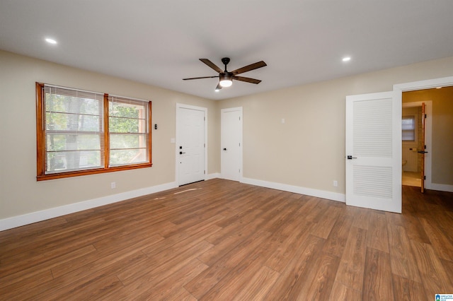 spare room with ceiling fan and wood-type flooring