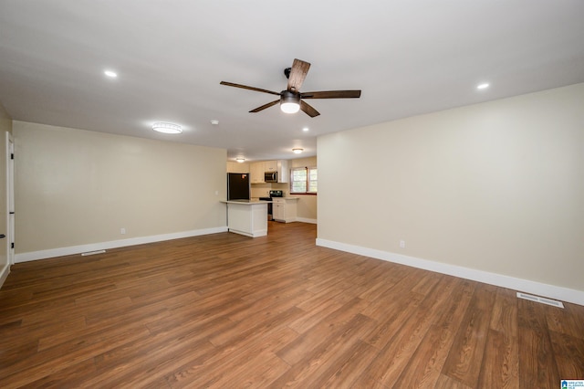 unfurnished living room with hardwood / wood-style flooring and ceiling fan