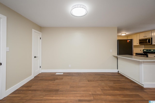 kitchen with black appliances and dark hardwood / wood-style floors