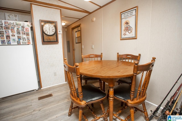 dining space with light hardwood / wood-style flooring