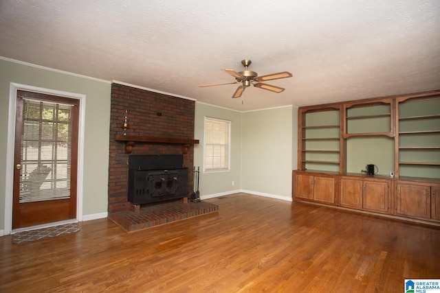 unfurnished living room featuring ornamental molding, hardwood / wood-style floors, a textured ceiling, and ceiling fan