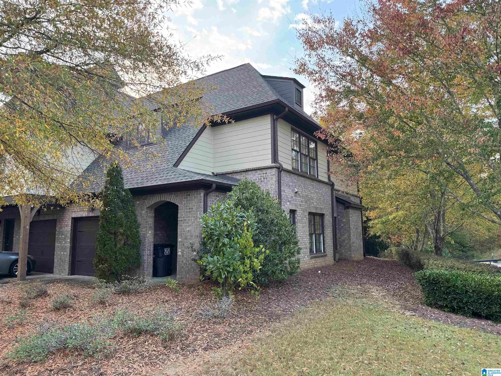 view of side of home with a garage