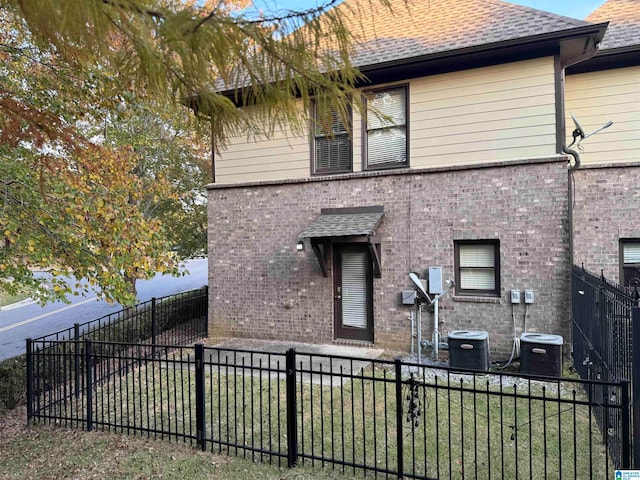 rear view of property with central AC unit