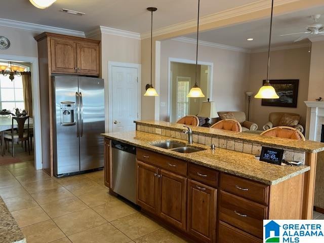 kitchen with appliances with stainless steel finishes, sink, ceiling fan with notable chandelier, hanging light fixtures, and crown molding