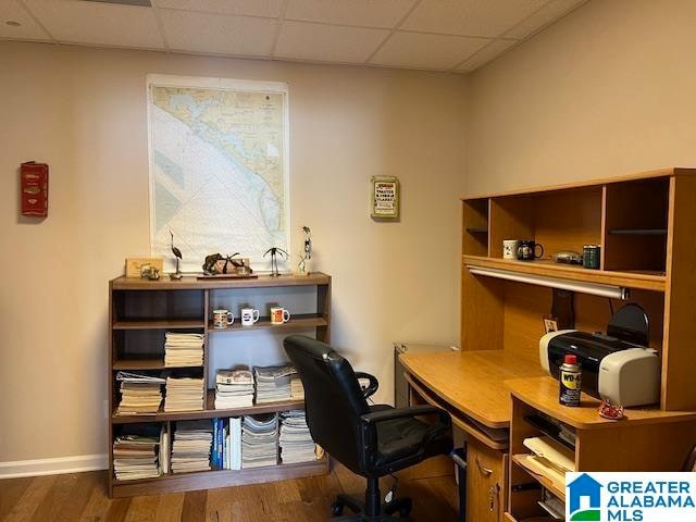 office with a paneled ceiling and dark hardwood / wood-style flooring