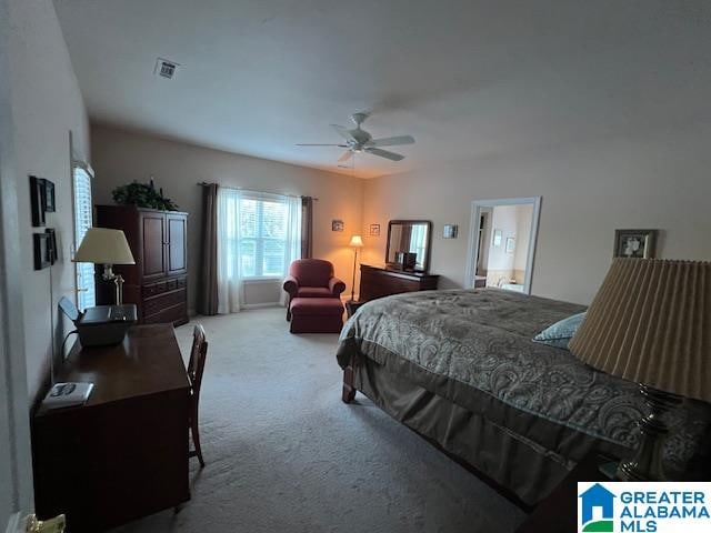 bedroom with ceiling fan and light carpet