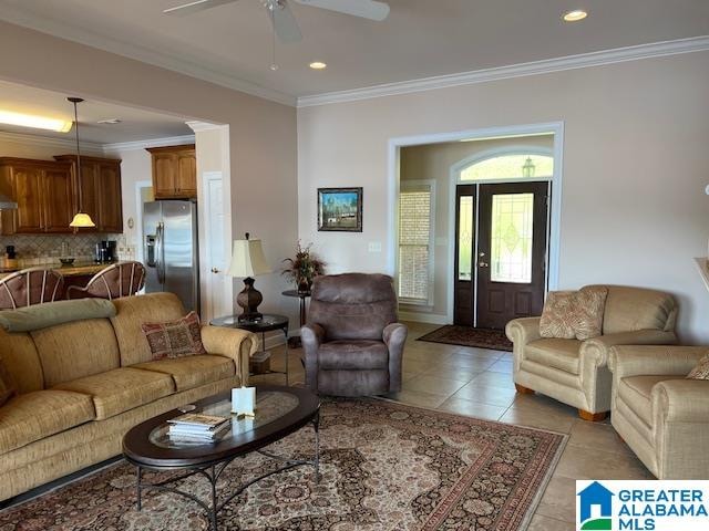 tiled living room featuring crown molding and ceiling fan