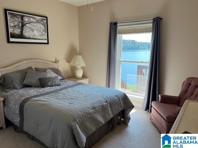 carpeted bedroom with a water view