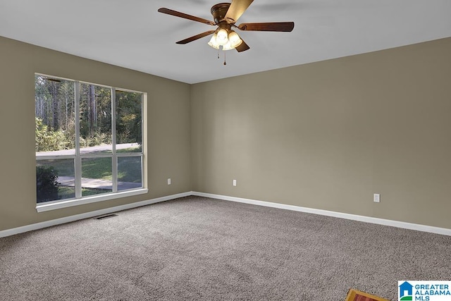 carpeted empty room featuring ceiling fan