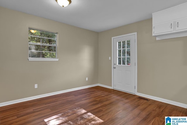 spare room with dark hardwood / wood-style flooring