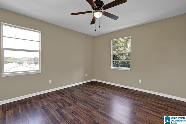 unfurnished room featuring ceiling fan and dark hardwood / wood-style flooring