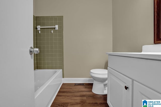 bathroom with toilet, hardwood / wood-style flooring, and vanity