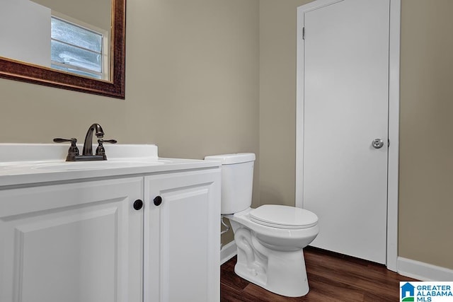 bathroom with vanity, hardwood / wood-style floors, and toilet