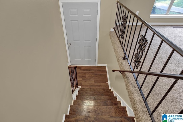 staircase featuring hardwood / wood-style flooring