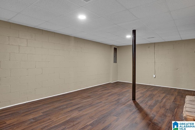 basement with a paneled ceiling and dark hardwood / wood-style flooring