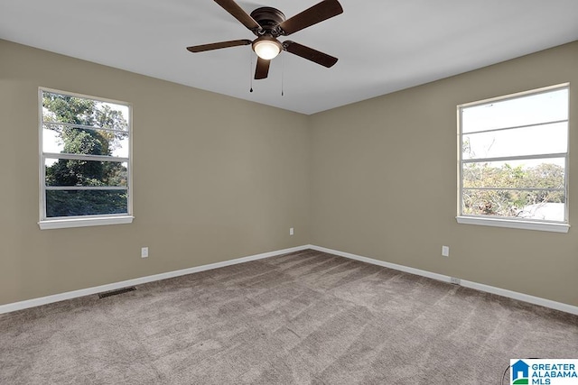 unfurnished room with ceiling fan and light colored carpet