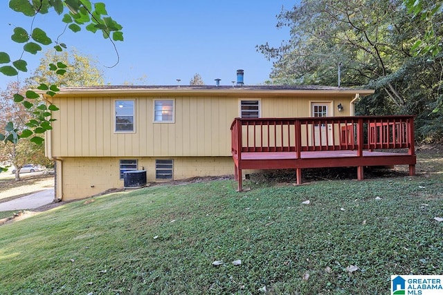 back of property with a wooden deck, central AC, and a yard