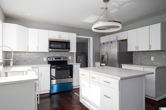 kitchen featuring sink, dark hardwood / wood-style floors, a kitchen island, white cabinetry, and stainless steel appliances