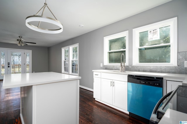 kitchen featuring hanging light fixtures, stainless steel dishwasher, dark hardwood / wood-style floors, a kitchen island, and white cabinetry