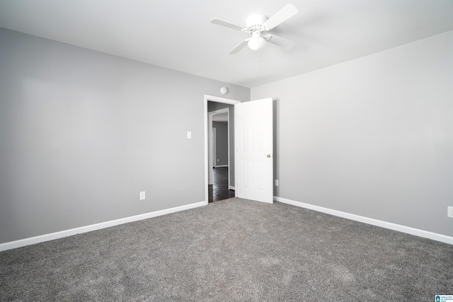 unfurnished bedroom featuring dark colored carpet and ceiling fan