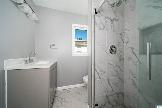 bathroom featuring toilet, vanity, and tiled shower