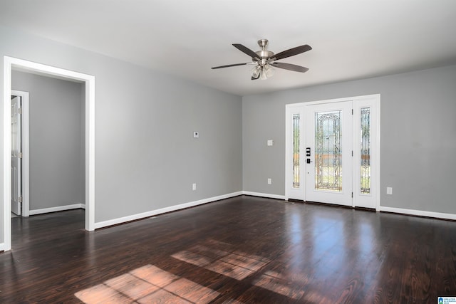 empty room featuring ceiling fan and dark wood-type flooring