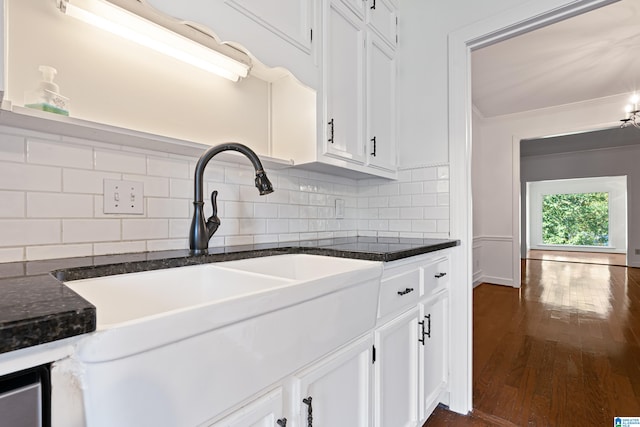 kitchen with decorative backsplash, white cabinetry, dark hardwood / wood-style floors, and dark stone countertops