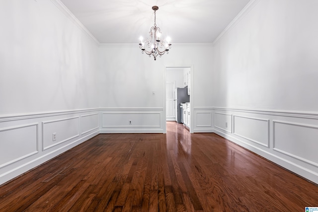 unfurnished room with ornamental molding, a chandelier, and dark hardwood / wood-style flooring