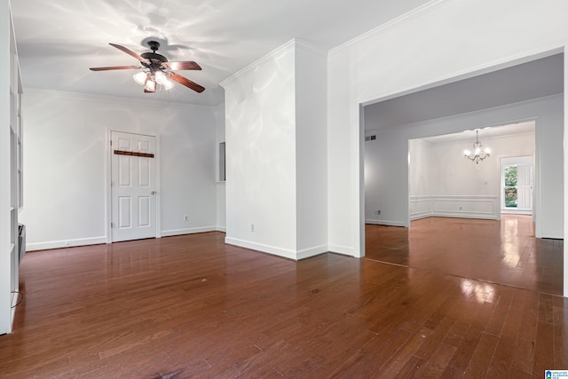 spare room with crown molding, dark hardwood / wood-style floors, and ceiling fan with notable chandelier