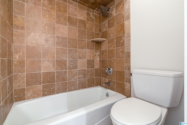 bathroom featuring toilet and tiled shower / bath