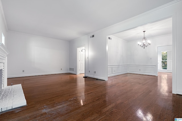 unfurnished living room with a notable chandelier, ornamental molding, and dark hardwood / wood-style floors