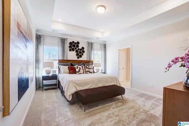 carpeted bedroom with connected bathroom, a raised ceiling, ornamental molding, and multiple windows