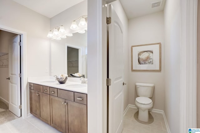 bathroom featuring vanity, toilet, and tile patterned floors