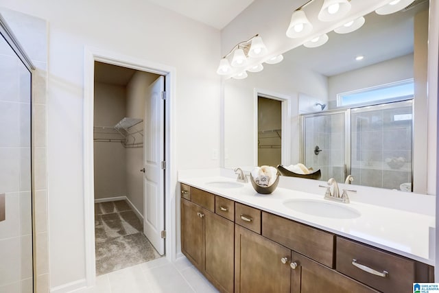 bathroom with vanity, tile patterned flooring, and an enclosed shower