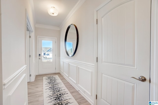 entryway featuring light hardwood / wood-style floors and ornamental molding